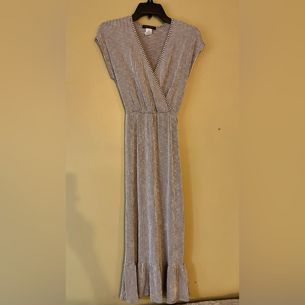 Cation to the wind light brown whits stripe maxi style dress, ties in the back.